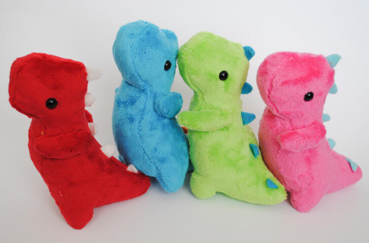 Dinosaur plushies made with my own pattern, featuring hand and machine sewn elements.