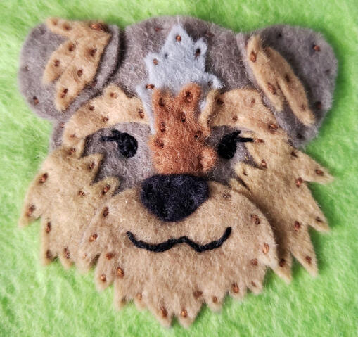 Hand-stitched felt portrait of my dog, Merlin