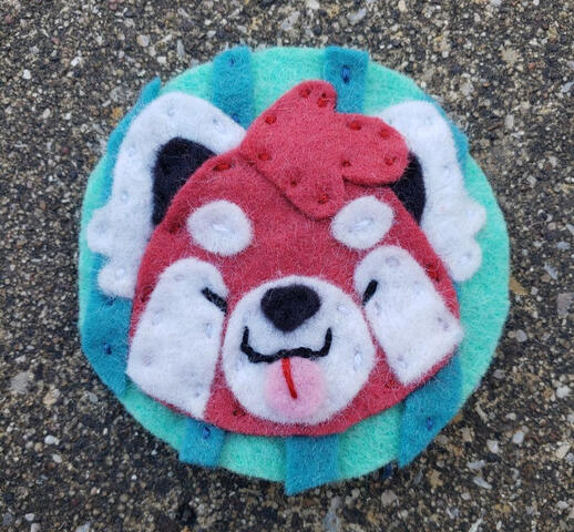 Hand-stitched felt red panda icon